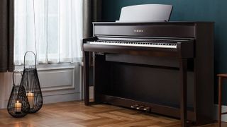 Yamaha Clavinova CLP-775 in a plush room against a teal wall