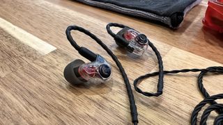 Westone Audio AM PRO X10 in-ear monitors on a wooden worktop